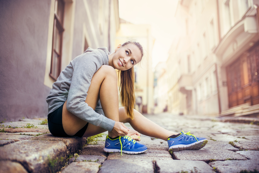 Woman tying shoelace