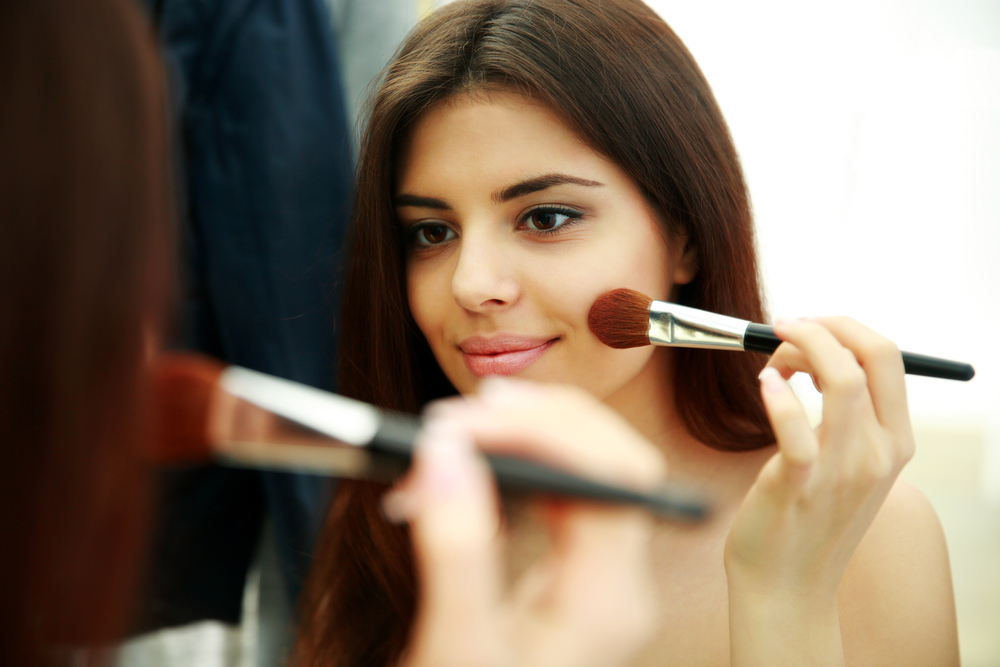 Woman applying makeup